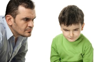 Dad disciplining son